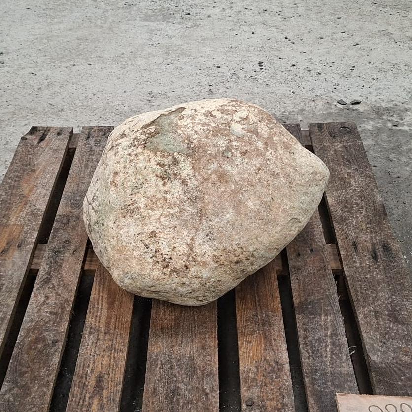 Unique glacial stone boulder displayed on a pallet outdoors.
