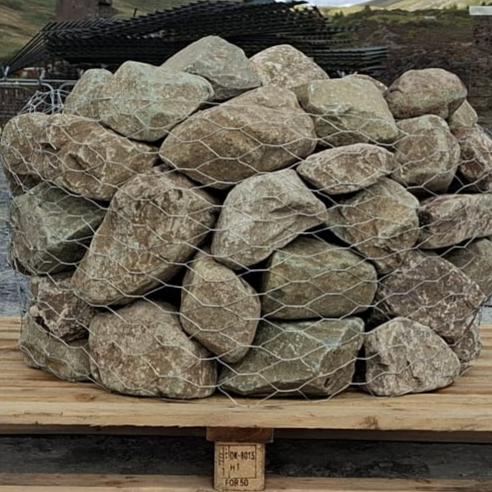 Close-up of netted glacial rockery stones with brown and grey surfaces