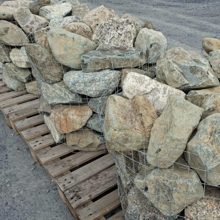 Pallet cages of mixed glacial stones showing broad faces and rounded edges