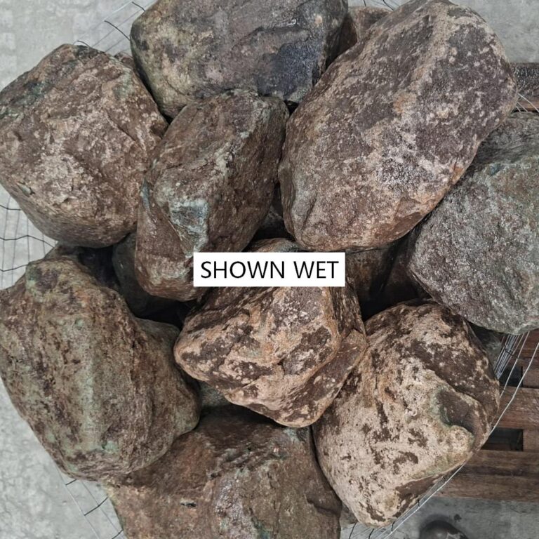 Wet glacial stones seen from above, showing brown and grey mottling