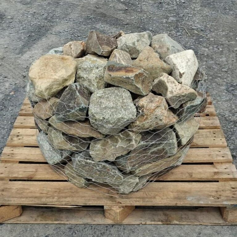 Mixed glacial rockery stones in a wire cage on a wooden pallet