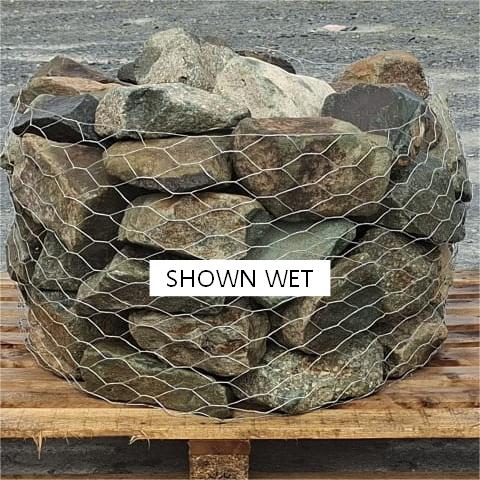 Wire cage of wet mixed glacial rockery stones on a pallet