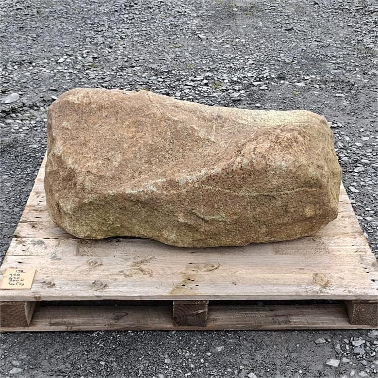 Long rounded glacial boulder with warm brown colouring and a shallow dip