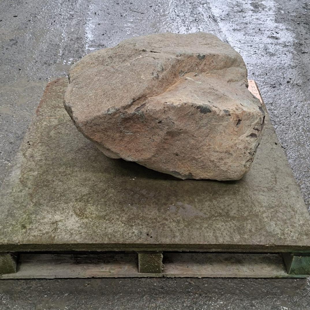 Garden stone boulder displayed on a pallet, with natural shape and colour.