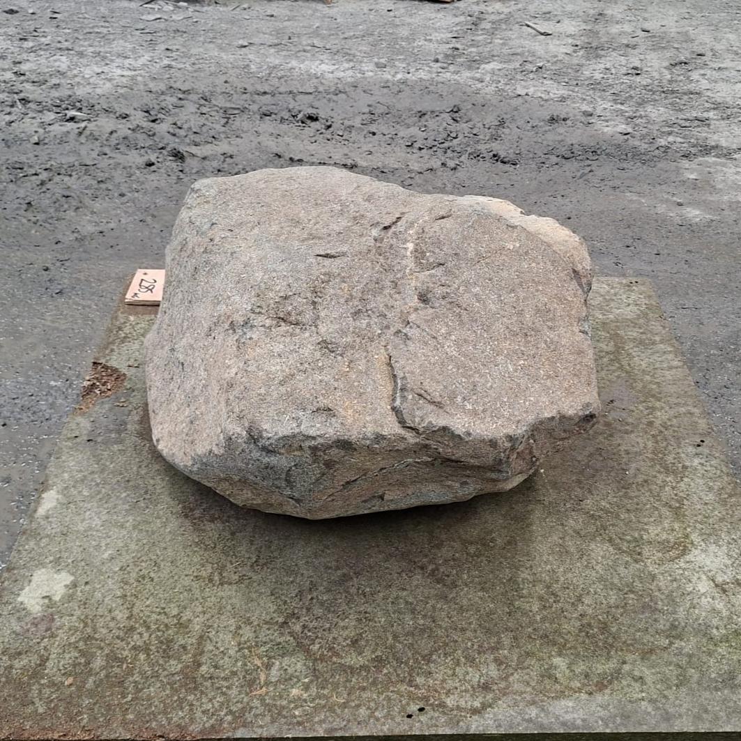 Garden stone boulder displayed on a pallet, showing natural shape and variations in colour and texture.