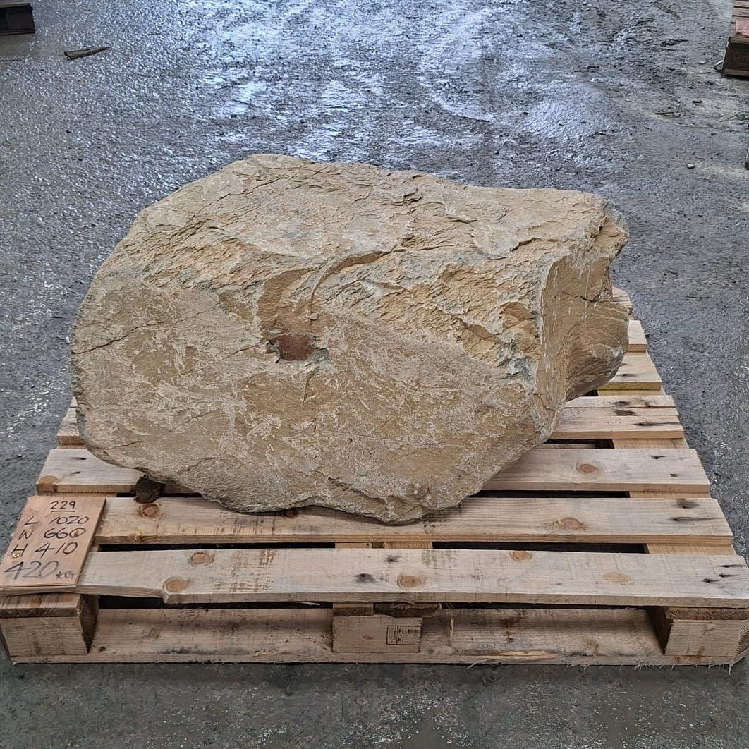 Unique stone boulder with natural colour tones on a wooden pallet.