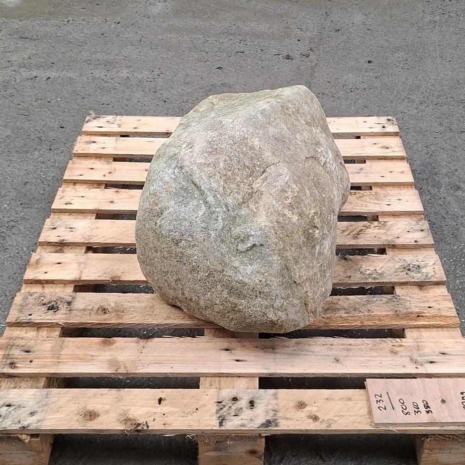Natural glacial boulder on a wooden pallet.