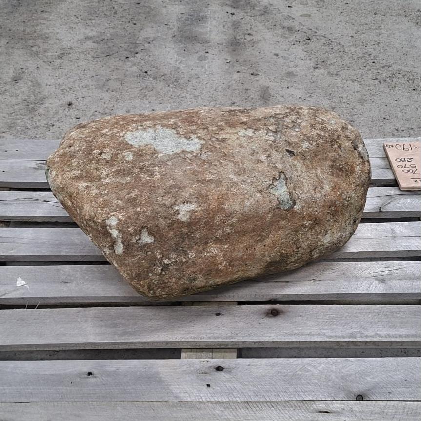 Side view of a glacial boulder, resting on a pallet.