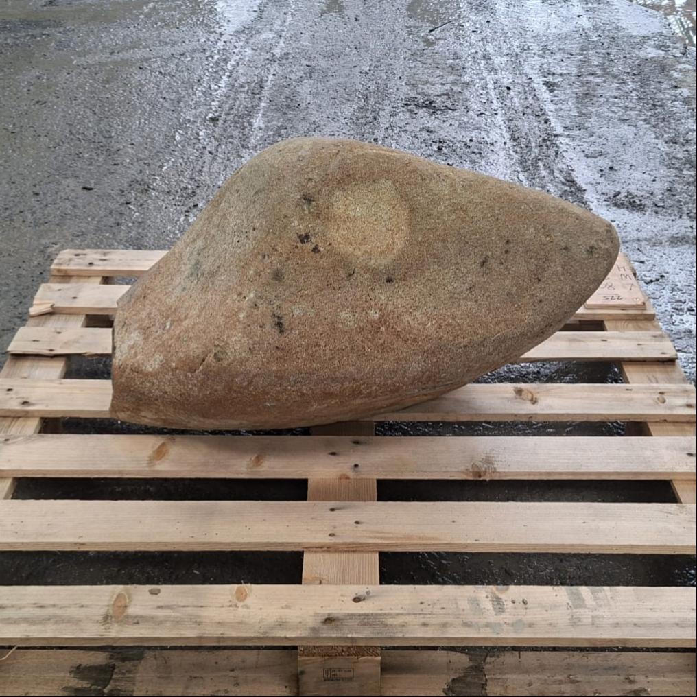 Glacial stone boulder with irregular shape, displayed on a wooden pallet.