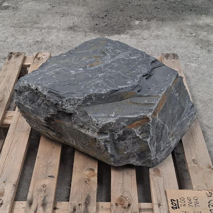 Welsh slate boulder showing rough broken edges and thin pale veins