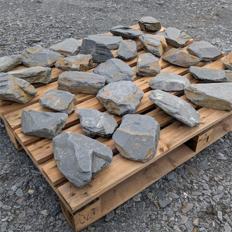 Mini Welsh slate stones arranged individually across a wooden pallet