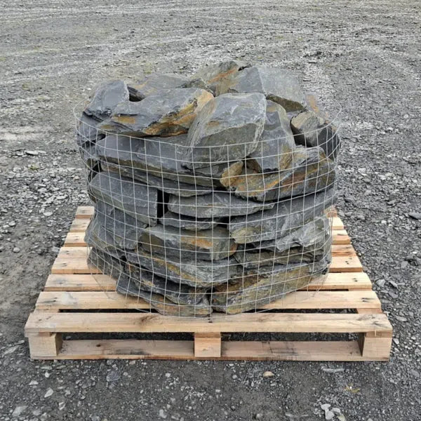 Pallet of grey and rusty slate rockery stones enclosed in wire mesh