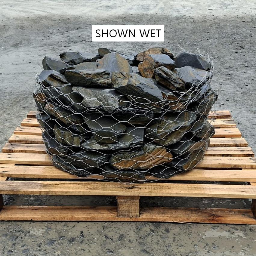 Wire cage of wet mini slate rockery stones on a wooden pallet