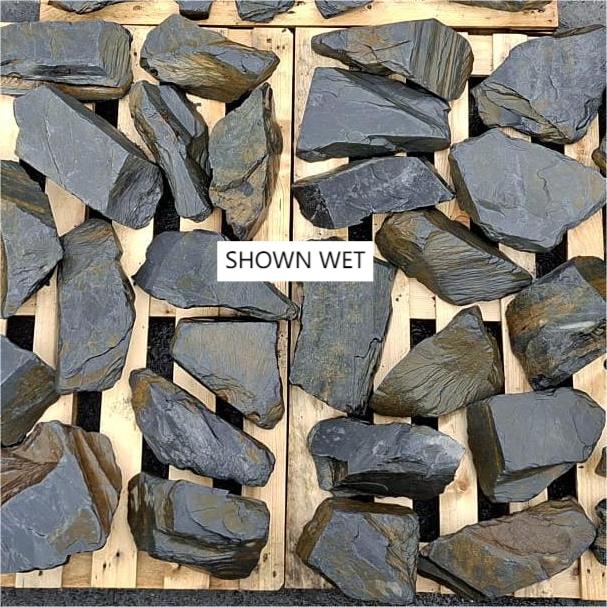 Wet slate stones spread out to show varied shapes and layered edges