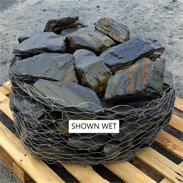 Wet slate rockery stones showing dark grey faces and ochre markings