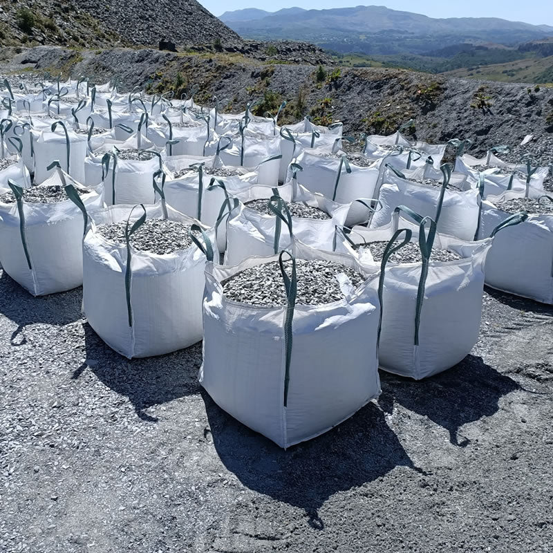 Bulk bags of Welsh slate chippings arranged in rows at a quarry