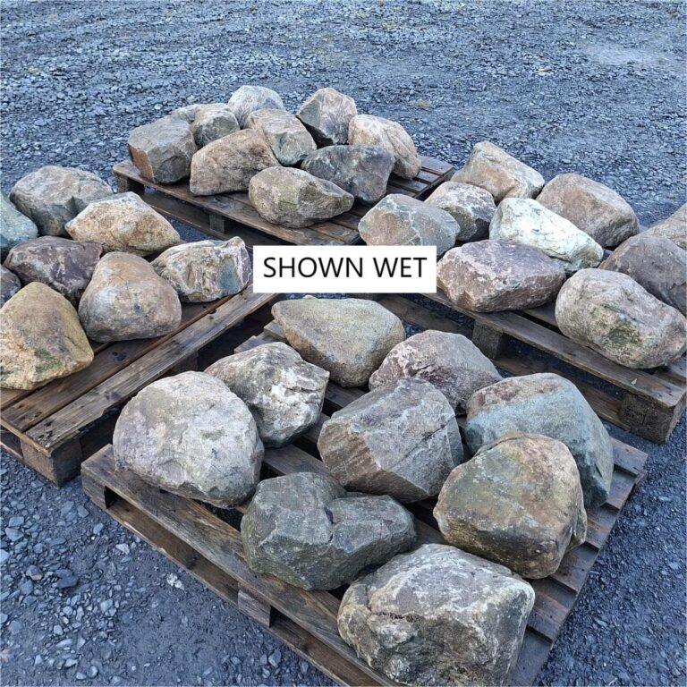 Several pallets of wet glacial boulders with varied shapes and colours