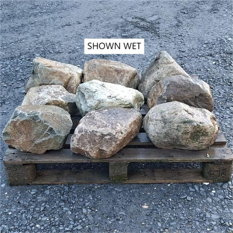 Wet glacial boulders arranged in rows, showing rounded and angular faces