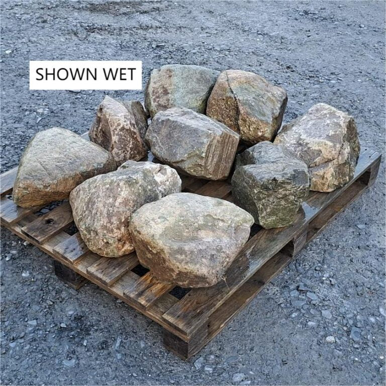 Wet glacial boulders arranged on a pallet, showing grey and brown surfaces