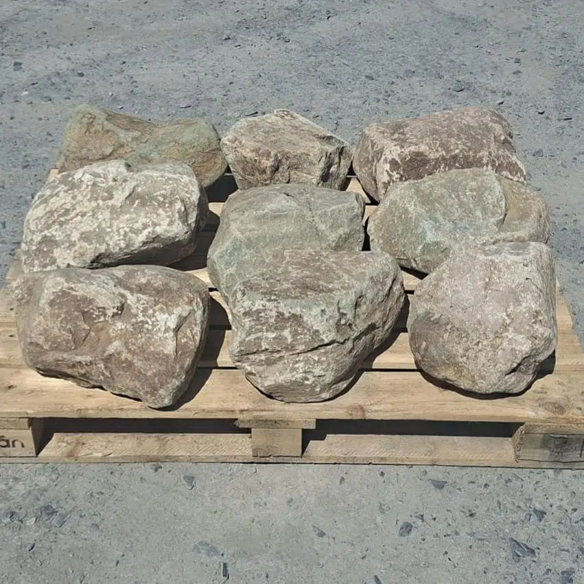 Glacial rockery boulders arranged in rows on a wooden pallet