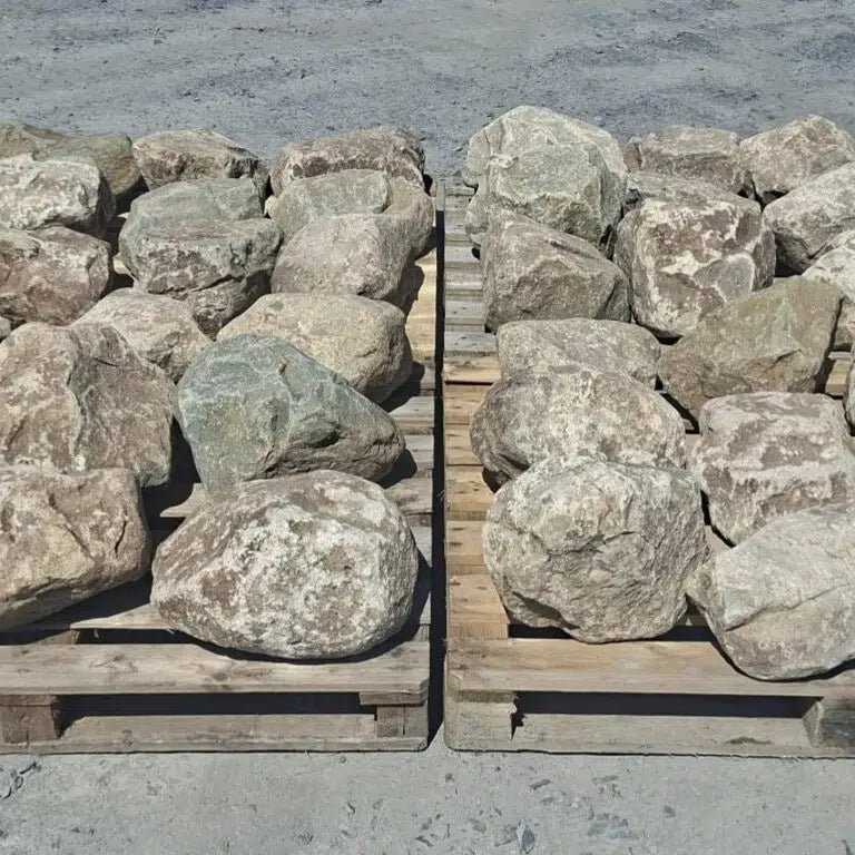 Two pallets of glacial rockery boulders arranged side by side