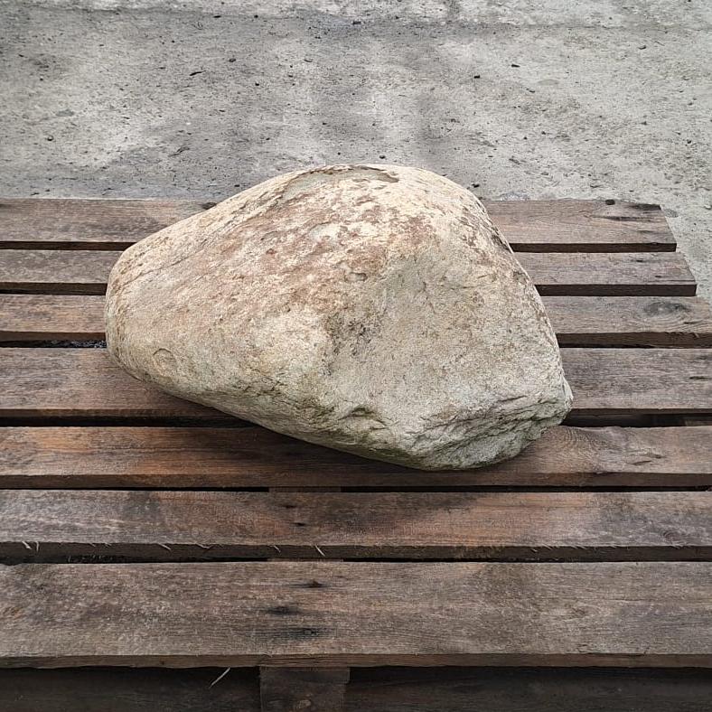 Unique glacial stone boulder displayed on a pallet.