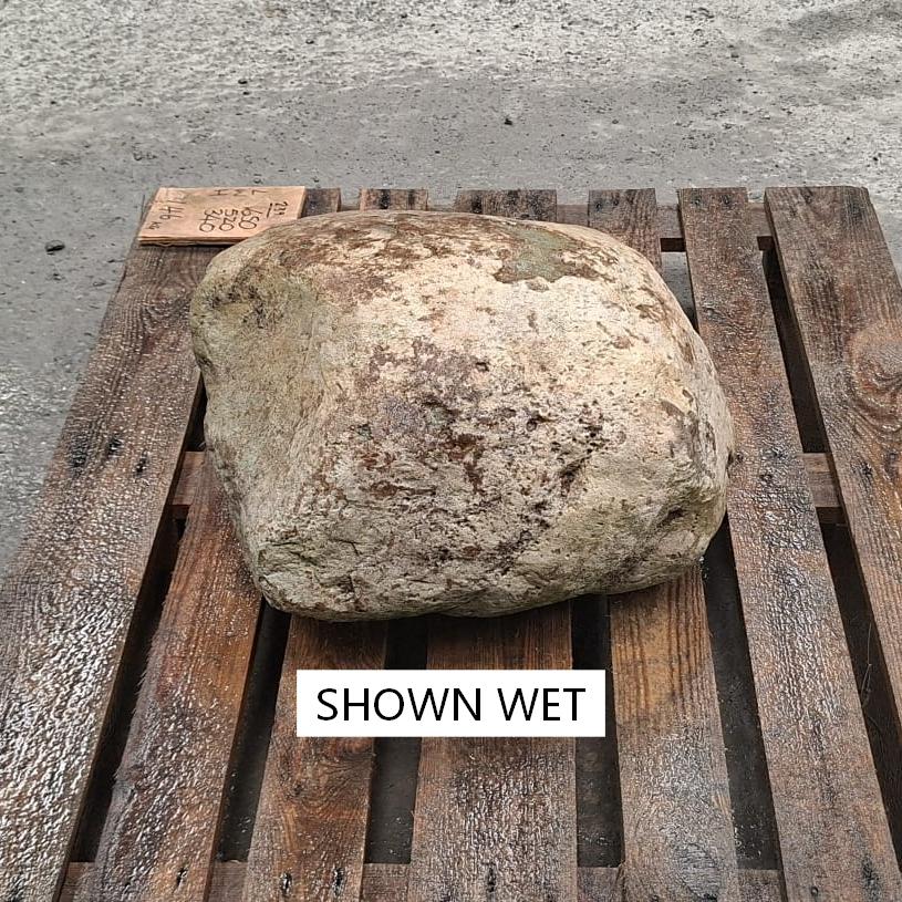Glacial boulder, shown wet and displayed on a pallet, with changing colours throughout.
