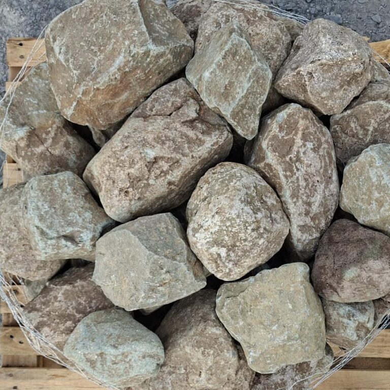 Close-up of dry glacial stones with pale green faces and brown markings