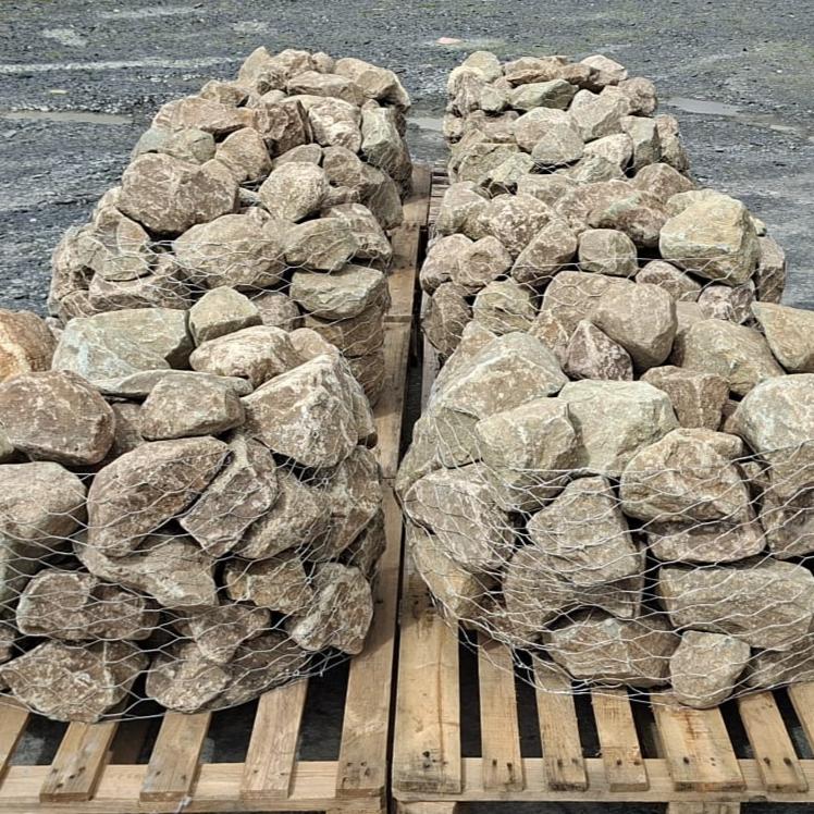 Rows of glacial rockery stone cages stacked on wooden pallets