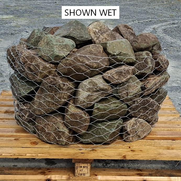 Wet glacial rockery stones showing darker green and brown colours