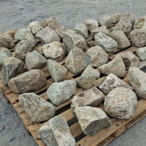 Dry mixed glacial stones arranged individually across wooden pallets