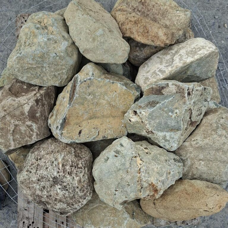 Mixed glacial stones seen from above, showing pale veins and speckled textures