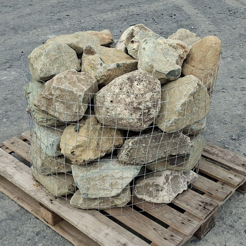 Caged glacial stones with varied angular shapes and mottled grey faces