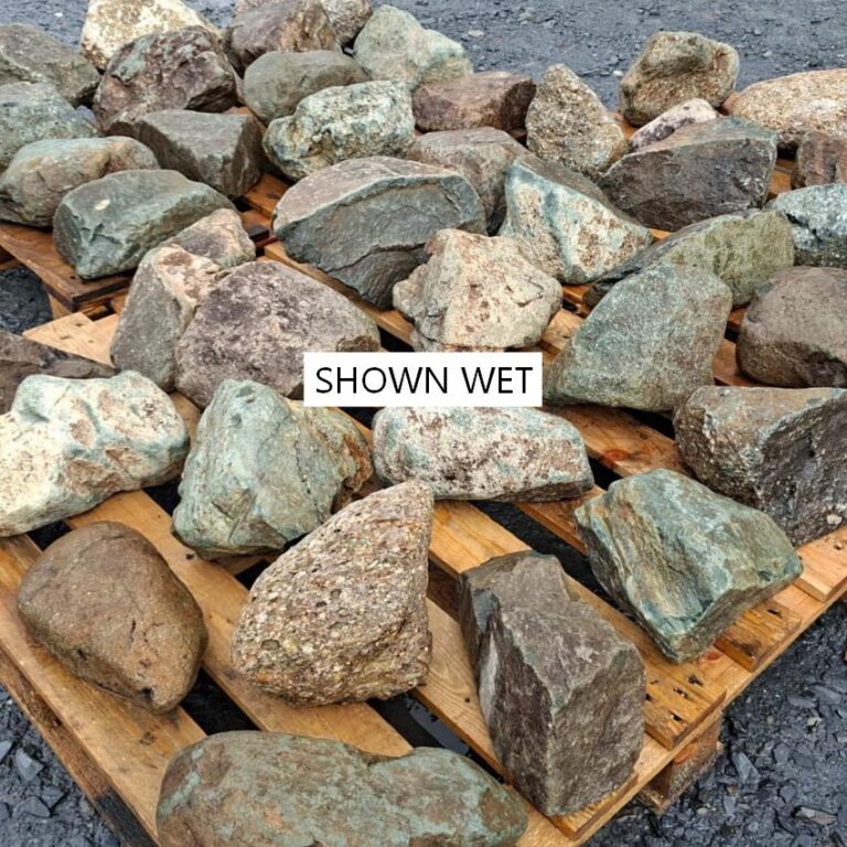 Wet mixed glacial stones laid out, showing speckled textures and varied shapes