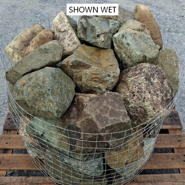 Wet mixed glacial stones showing greenish faces and dark brown mottling