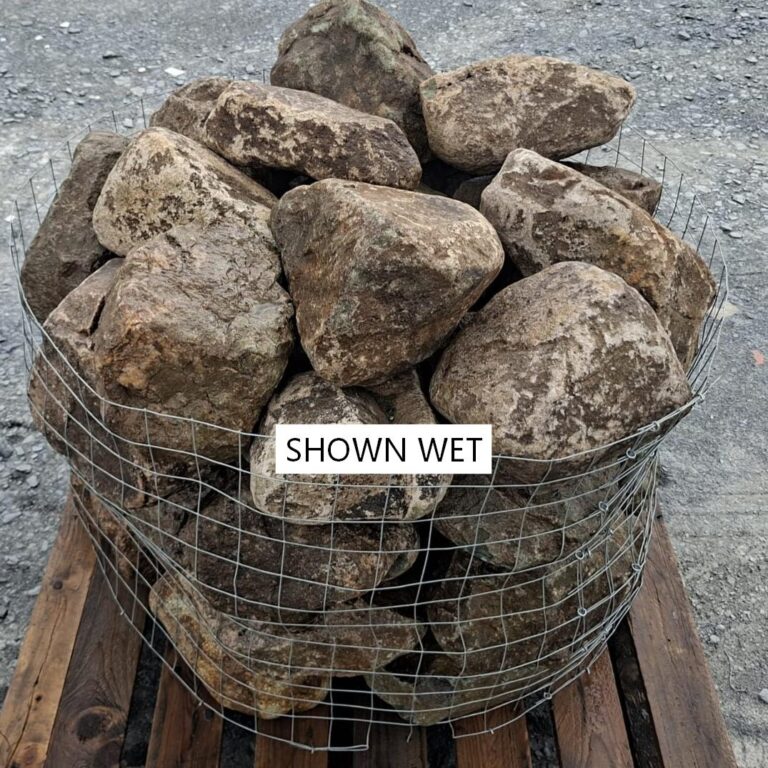 Wet glacial rockery stones showing dark brown faces at the top of a cage