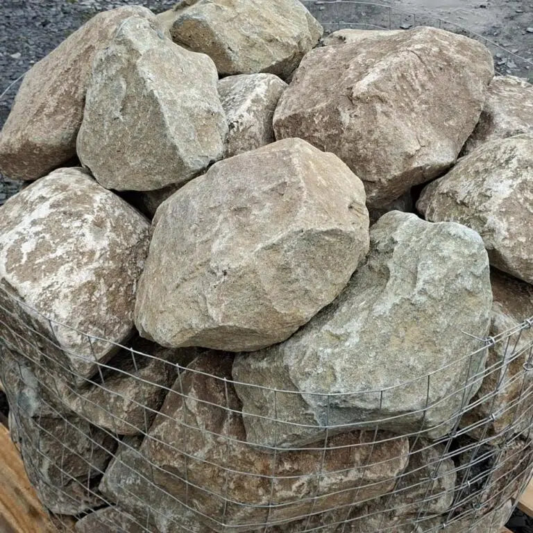 Close-up of dry glacial stones with rounded edges and pale greenish faces