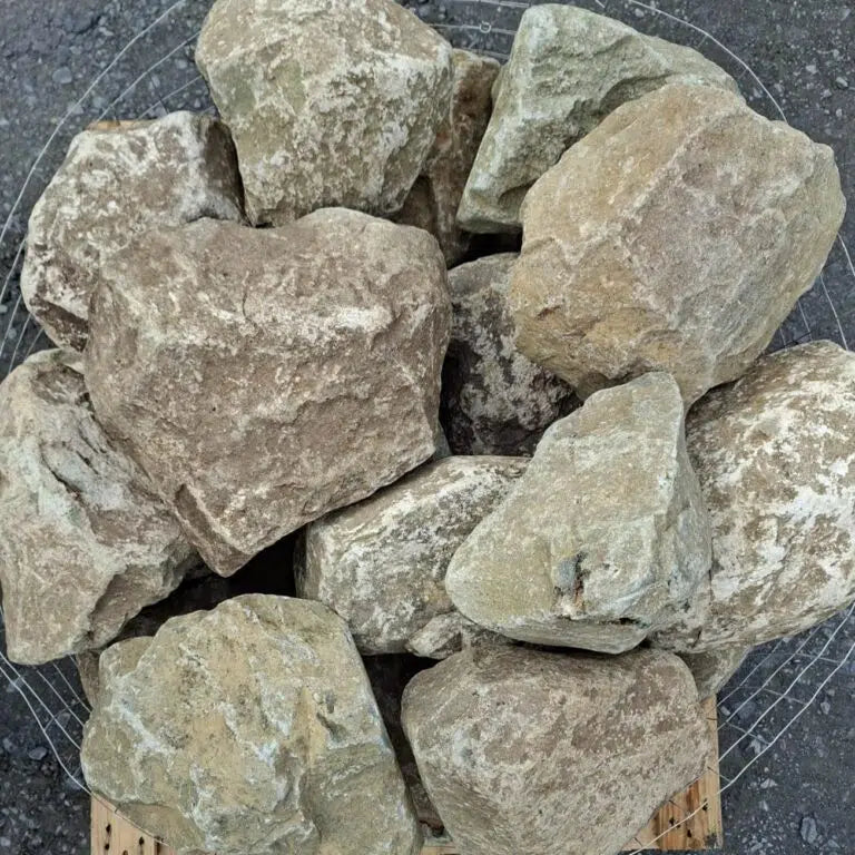 Dry glacial stones seen from above, showing pale patches and irregular faces