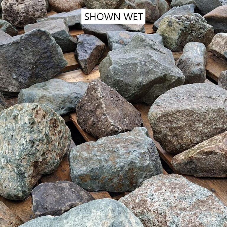 Wet glacial stones showing dark faces and coarse speckled textures