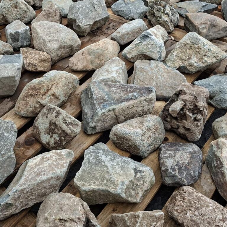 Mixed glacial stones showing speckled surfaces and pale veins