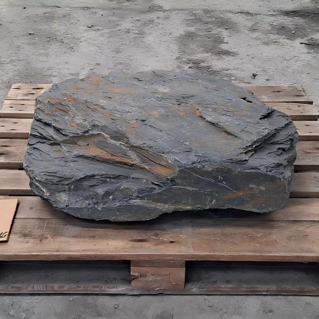 Broad Welsh slate boulder with thin grey layers and rusty markings