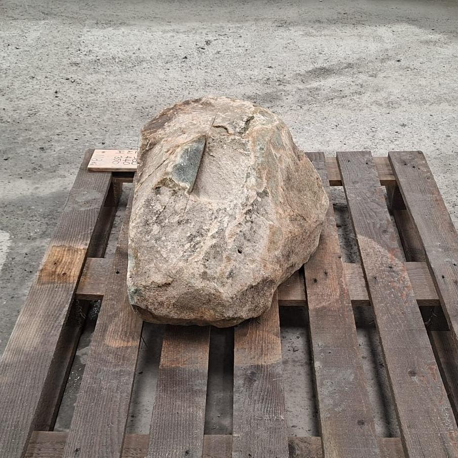Glacial boulder with rough natural finish, sitting on a wooden pallet.
