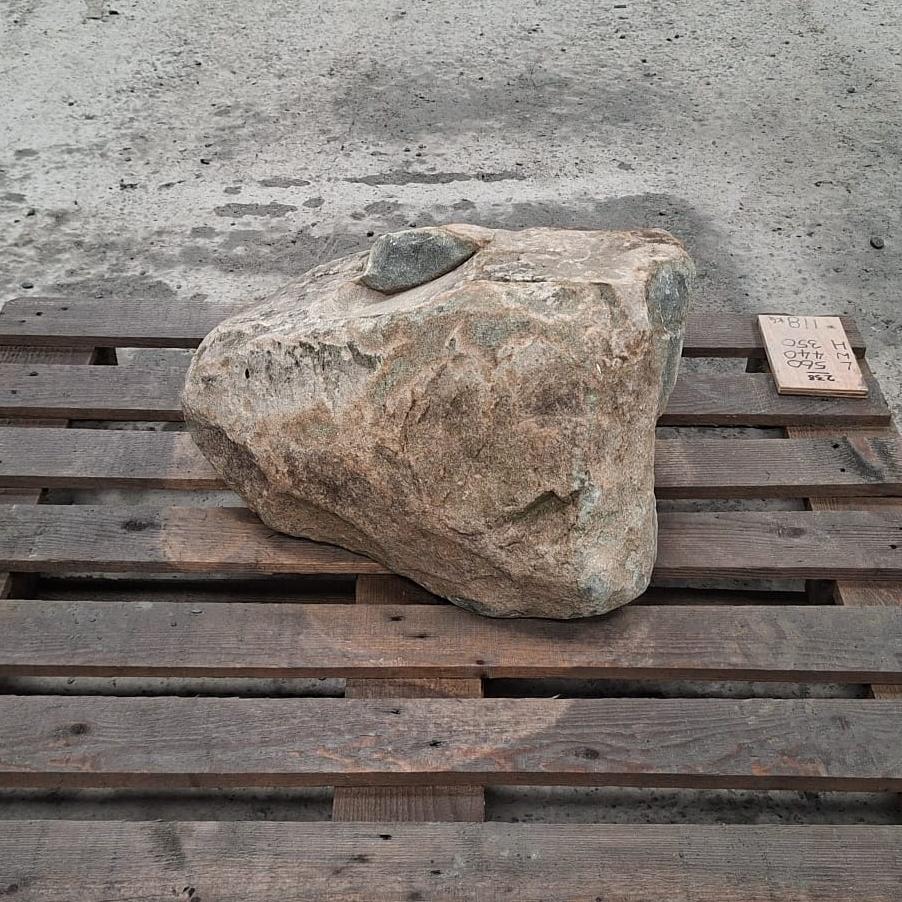 A glacial boulder with rough natural textures and varying earthy colour tones.