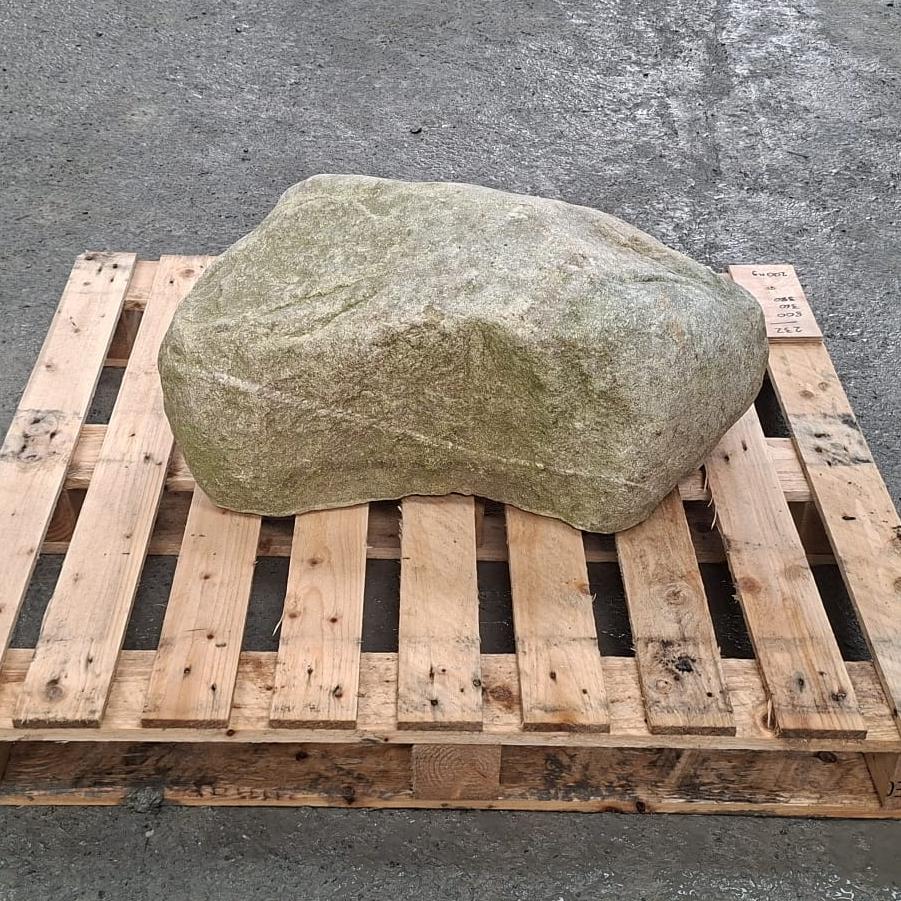 Natural curved side of a glacial stone boulder, shown on a pallet.