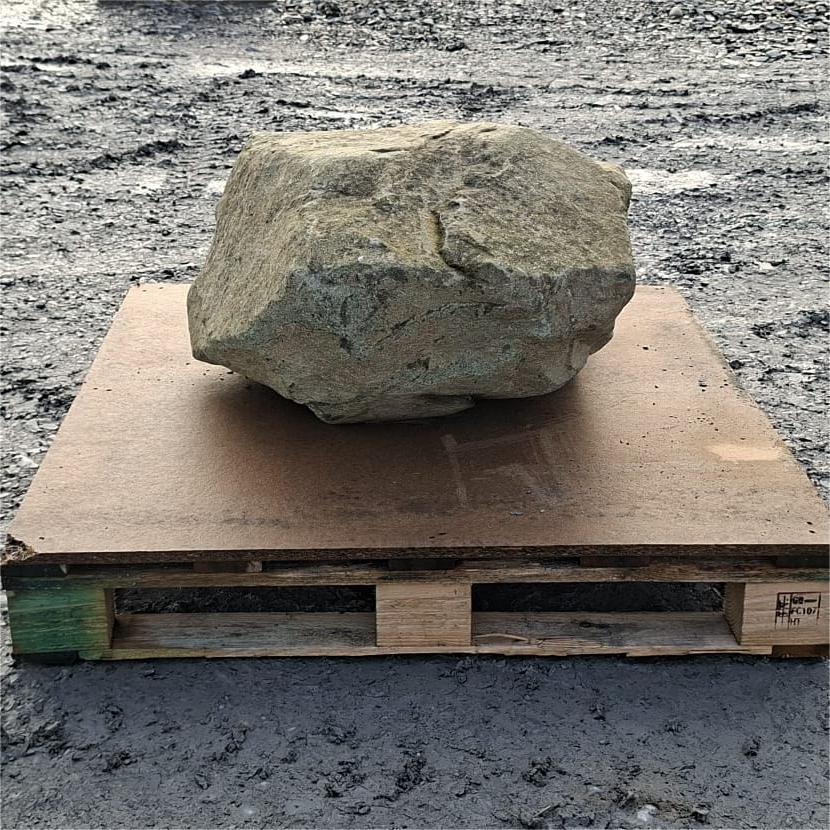 Glacial boulder showing a blocky shape and dark grey lower face