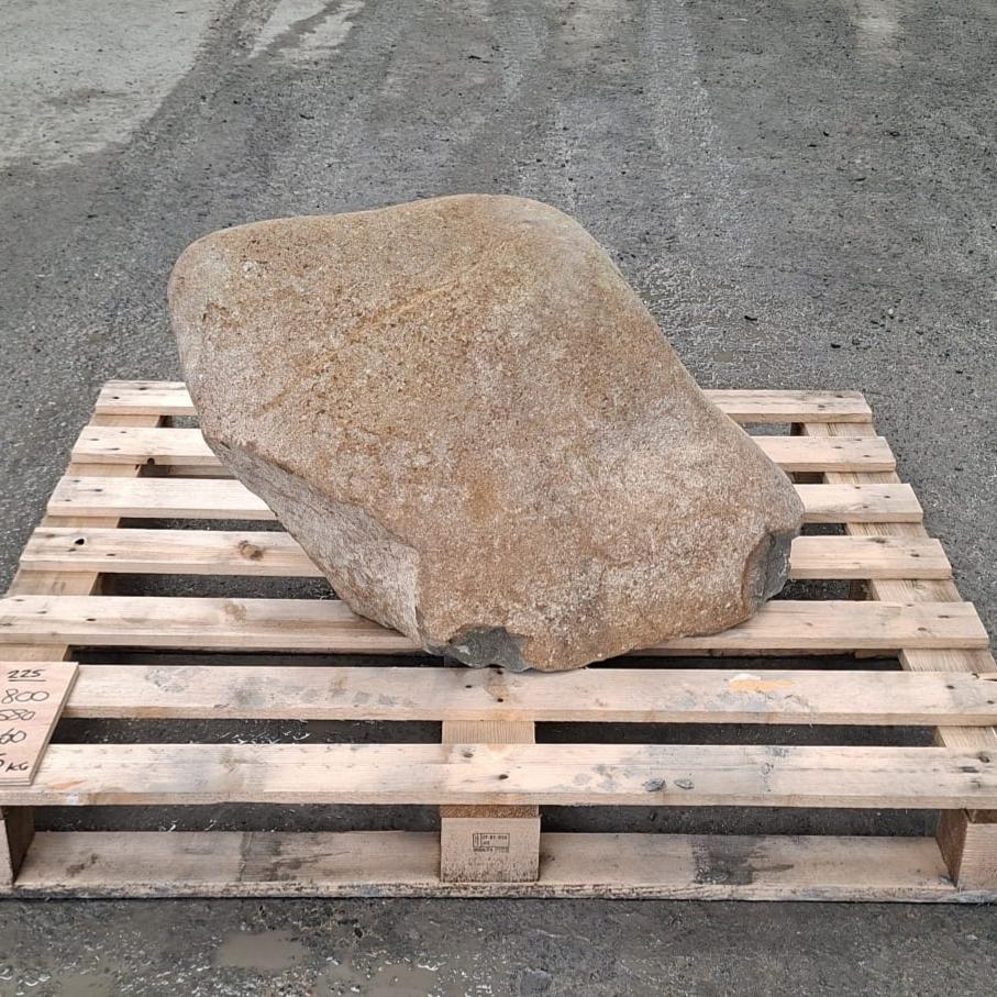 Glacial stone boulder with irregular shape, sitting on a wooden pallet.
