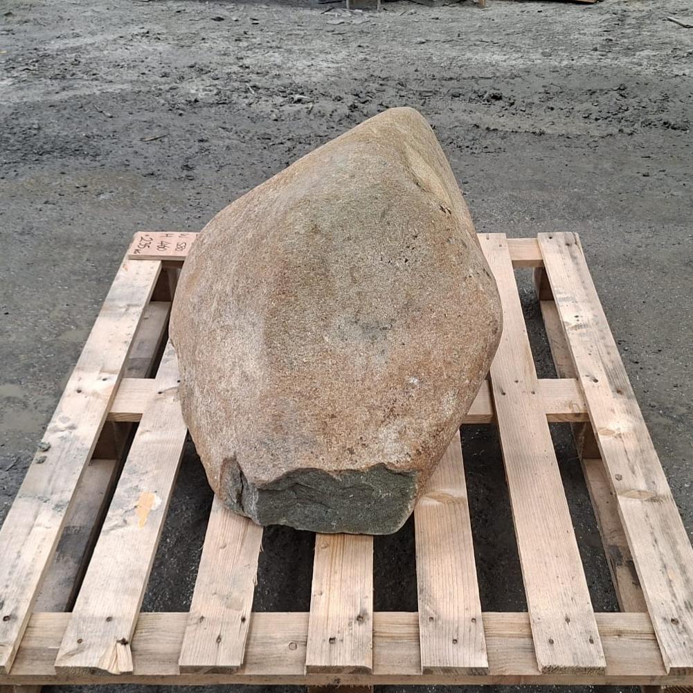 Glacial stone natural boulder with irregular shape, sitting on a wooden pallet.