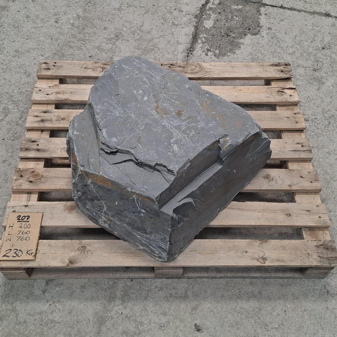 Slate boulder seen from above, showing its angular outline and stepped top