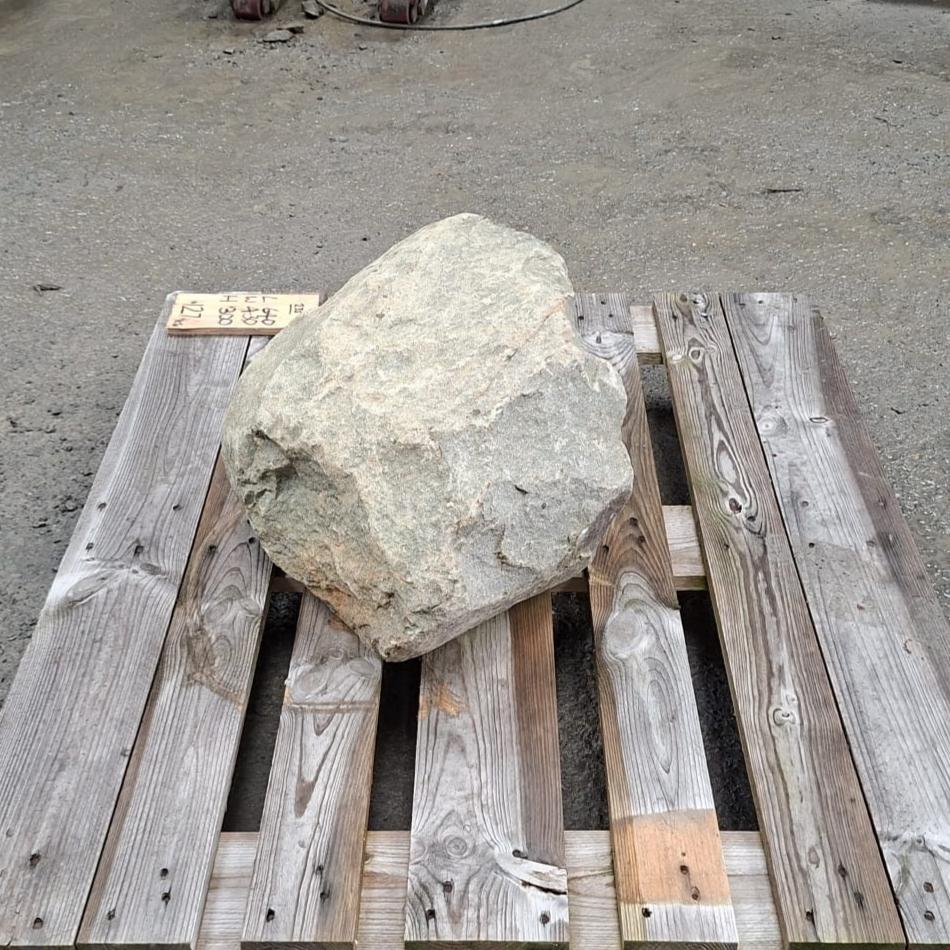 Irregular shaped garden boulder, with natural variations.