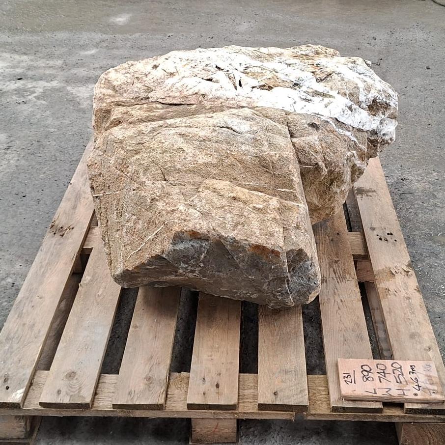 A large irreuglar shaped glacial boulder with natural variations and imperfections.